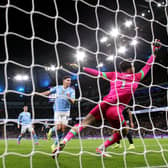 MANCHESTER, ENGLAND - JANUARY 31: Julian Alvarez of Manchester City scores his team's first goal past James Trafford of Burnley during the Premier League match between Manchester City and Burnley FC at Etihad Stadium on January 31, 2024 in Manchester, England. (Photo by Alex Livesey/Getty Images)