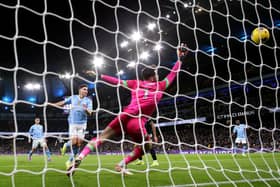 MANCHESTER, ENGLAND - JANUARY 31: Julian Alvarez of Manchester City scores his team's first goal past James Trafford of Burnley during the Premier League match between Manchester City and Burnley FC at Etihad Stadium on January 31, 2024 in Manchester, England. (Photo by Alex Livesey/Getty Images)