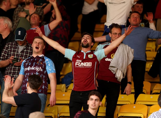WATFORD, ENGLAND - APRIL 30: Burnley fans celebrate at full time after the Premier League match between Watford and Burnley at Vicarage Road on April 30, 2022 in Watford, England. (Photo by Julian Finney/Getty Images)
