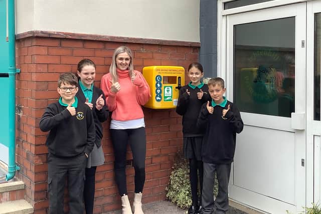 Jodie Sutcliffe pictured with year six students at Ightenhill Primary School in Burnley and their new defibrillator