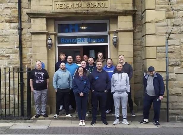 Andy and Rio Powell (centre front) with the team at Healthier Heroes in Burnley