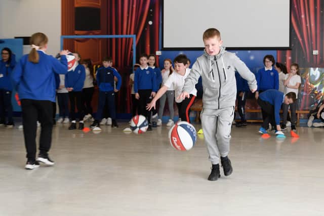 Year 6 pupils from Padiham Primary School play basketball games organised by the tallest man in the UK Paul Sturgess. Photo: Kelvin Stuttard