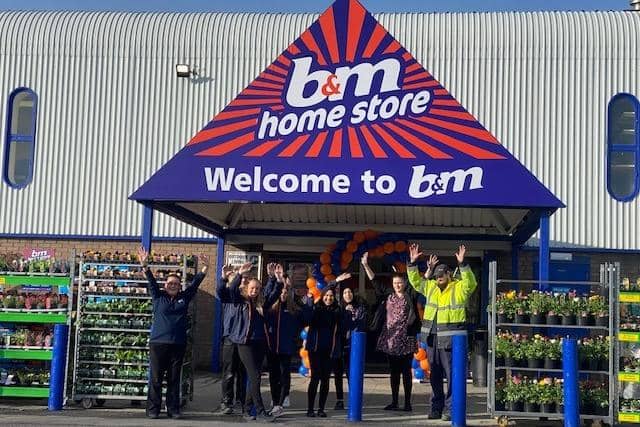 The team at Emmaus Burnley help to officially unveil the refurbished B&M store.