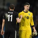 Burnley's New Zealand striker Chris Wood (L) and Burnley's English goalkeeper Nick Pope (R) react at the end of the English FA Cup fourth round football match between Manchester City and Burnley at the Etihad Stadium in Manchester, north west England, on January 26, 2019.