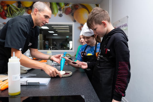 David Webb, Development Chef teaches youngsters on a cookery course at the Down Town Kitchen & Cafe in Burnley Town Centre. Photo: Kelvin Lister-Stuttard