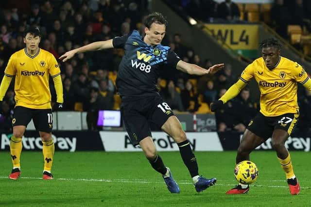 WOLVERHAMPTON, ENGLAND - DECEMBER 05:  Jean-Ricner Bellegarde of Wolverhampton Wanderers controls the ball watched by Hjalmar Ekdal during the Premier League match between Wolverhampton Wanderers and Burnley FC at Molineux on December 05, 2023 in Wolverhampton, England. (Photo by David Rogers/Getty Images)