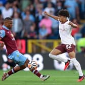 BURNLEY, ENGLAND - AUGUST 11: Rico Lewis of Manchester City runs with the ball whilst under pressure from Lyle Foster of Burnley during the Premier League match between Burnley FC and Manchester City at Turf Moor on August 11, 2023 in Burnley, England. (Photo by Nathan Stirk/Getty Images)