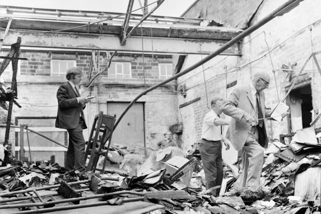 Assessors work out the massive bill caused by the fire. The roof was completely ruined in the blaze.
Burnley firemen were complimented yesterday, the 26th July 1971, by a local boss for bravery in tackling a multi-thousand-pound blaze on his firm's premises. In turn, Pendlefin Studios Ltd was congratulated for "good housekeeping" on fire precautions by Deputy Chief Fire Officer Mr P. Copley. Pendlefin Studios lost its entire stock of hand-painted models, valued at more than £5,000, when fire gutted the packaging section at the Bracewell Street studios.