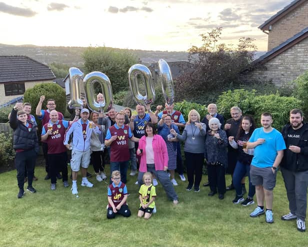 Burnley fan Chris Hogan (front left) with his wife Sam and their family and friends to to celebrate his 1,000th home game