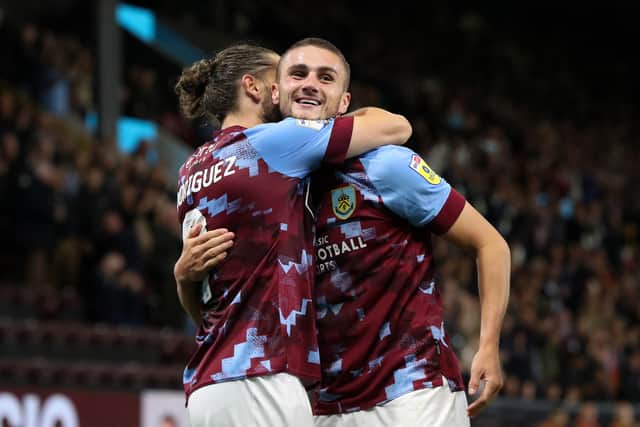 BURNLEY, ENGLAND - AUGUST 30: Taylor Harwood-Bellis of Burnley celebrates with goal scorer Jay Rodriguez during the Sky Bet Championship between Burnley and Millwall at Turf Moor on August 30, 2022 in Burnley, England. (Photo by Alex Livesey/Getty Images)