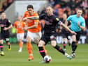 Burnley's Ashley Barnes releases a pass despite the attentions of Blackpool's Kenny Dougall

The EFL Sky Bet Championship - Blackpool v Burnley - Saturday 4th March 2023 - Bloomfield Road - Blackpool