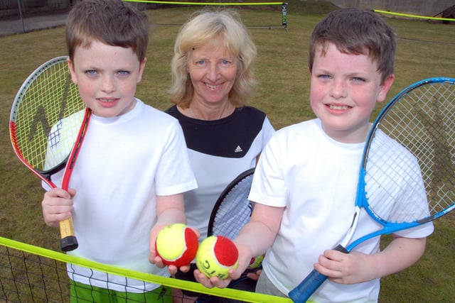 A Mansfield Lawn Tennis Club Open Day is enjoyed by twins, 9 year old Harry, left, and Jack Blackwell, with club member Ann Brown, who won the Wimbledon Veterans title in 2010 for the second time.