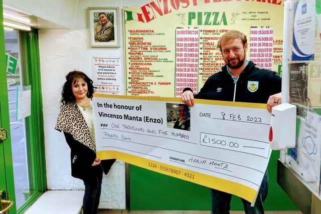 Mrs Maria Manta, Enzo's wife, presents the cheque to Peter Briggs.