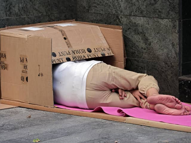 A homeless person sleeps in a street. (Photo by Thomas COEX / AFP) (Photo by THOMAS COEX/AFP via Getty Images)