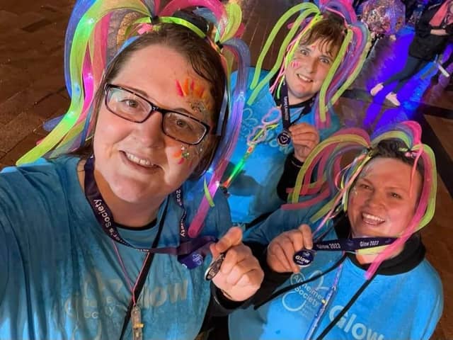 Pictured (left to right) Courtney Leyland, Catherine Mayer and Sam Graham were among 1,500 taking part in the walk in glow in the dark clothes and accessories.