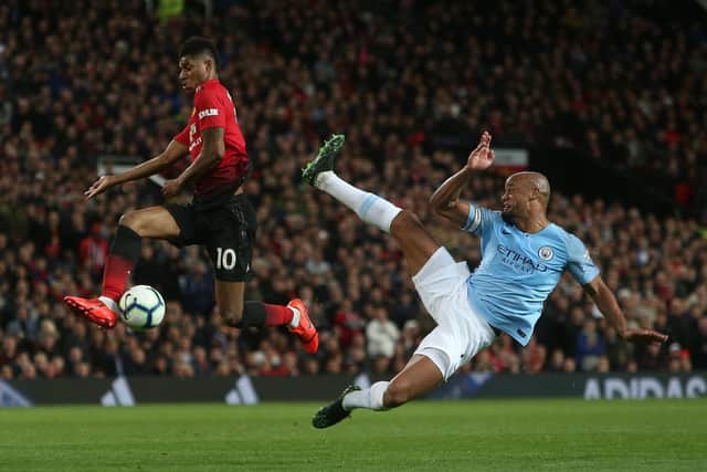 MANCHESTER, ENGLAND - APRIL 24: Marcus Rashford of Manchester United in action with Vincent Kompany of Manchester City during the Premier League match between Manchester United and Manchester City at Old Trafford on April 24, 2019 in Manchester, United Kingdom. (Photo by John Peters/Manchester United via Getty Images)