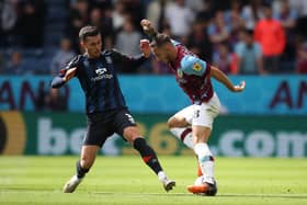 BURNLEY, ENGLAND - AUGUST 06: Josh Brownhill of Burnley FC keeps the ball from Daniel Potts of Luton Town during the Sky Bet Championship match between Burnley and Luton Town at Turf Moor on August 06, 2022 in Burnley, England. (Photo by Ashley Allen/Getty Images)