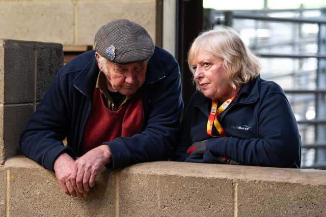 Nurse Janet Thomas speaks to one of the farmers at Gisburn Auction Mart