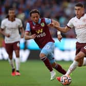 BURNLEY, ENGLAND - AUGUST 11: Phil Foden of Manchester City runs with the ball whilst under pressure from Luca Koleosho of Burnley during the Premier League match between Burnley FC and Manchester City at Turf Moor on August 11, 2023 in Burnley, England. (Photo by Nathan Stirk/Getty Images)
