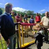 Coun. John Harbour (left) and Coun. Martyn Hurt (right) with local children and parents at the newly refurbished play area.