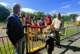 Coun. John Harbour (left) and Coun. Martyn Hurt (right) with local children and parents at the newly refurbished play area.