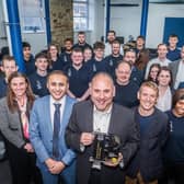 Burnley Council chief executive Lukman Patel, Process Instruments managing director (with award) and Coun. Scott Cunliffe (front left, centre and right) with company staff and council representatives. Photo: Andy Ford