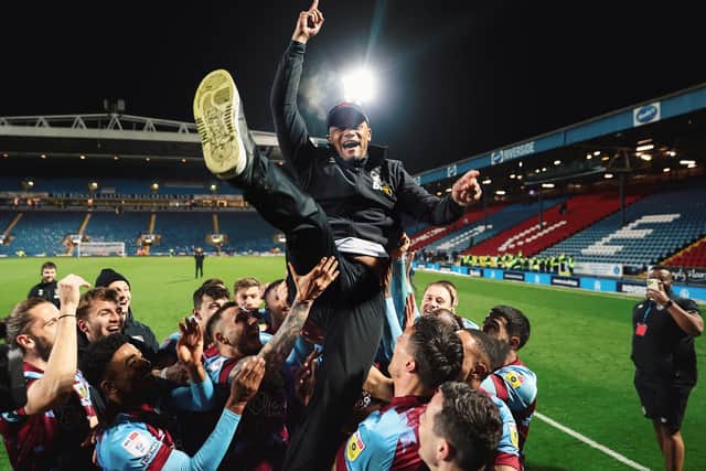 BLACKBURN, ENGLAND - APRIL 25: Vincent Kompany, Manager of Burnley, is lifted up by his players after winning the Sky Bet Championship following victory against Blackburn Rovers after the Sky Bet Championship between Blackburn Rovers and Burnley at Ewood Park on April 25, 2023 in Blackburn, England. (Photo by Matt McNulty/Getty Images)