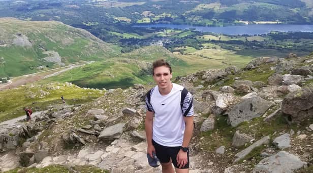 Mason Brewer, who works at Nelson and Colne College, has signed up to take part in a trek to the K2 mountain base camp bordering Pakistan and China in 2025. He is pictured here hiking the Old Man of Coniston as part of his training