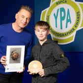 Chris Packham presents Burnley's Blessed Trinity pupil Corbyn Thomas with his RSPCA award
