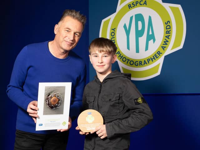 Chris Packham presents Burnley's Blessed Trinity pupil Corbyn Thomas with his RSPCA award