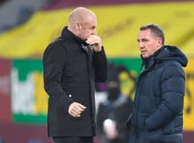 Burnley's English manager Sean Dyche (L) greets Leicester City's Northern Irish manager Brendan Rodgers (R) ahead of the English Premier League football match between Burnley and Leicester City at Turf Moor in Burnley, north west England on March 3, 2021.