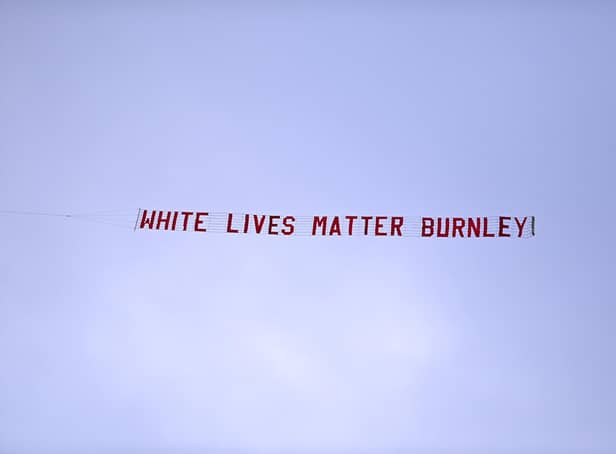 MANCHESTER, ENGLAND - JUNE 22: A plane flies over the stadium with a banner reading 'White Lives Matter Burnley'  during the Premier League match between Manchester City and Burnley FC at Etihad Stadium on June 22, 2020 in Manchester, England. Football stadiums around Europe remain empty due to the Coronavirus Pandemic as Government social distancing laws prohibit fans inside venus resulting in all fixtures being played behind closed doors. (Photo by Shaun Botterill/Getty Images)