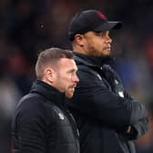 HULL, ENGLAND - MARCH 15: Craig Bellamy (L), Assistant Manager of Burnley looks on with Vincent Kompany, Manager of Burnley, during the Sky Bet Championship between Hull City and Burnley at MKM Stadium on March 15, 2023 in Hull, England. (Photo by George Wood/Getty Images)