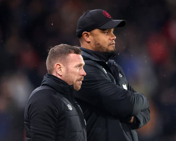 HULL, ENGLAND - MARCH 15: Craig Bellamy (L), Assistant Manager of Burnley looks on with Vincent Kompany, Manager of Burnley, during the Sky Bet Championship between Hull City and Burnley at MKM Stadium on March 15, 2023 in Hull, England. (Photo by George Wood/Getty Images)