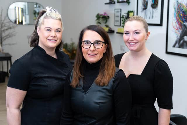 Gail Simpson, owner of Reflections hair and beauty salon, Burnley, (centre) with her daughters,  Michaela Simpson (left) and Maddison Stevenson. Gail is celebrating 31 years owning the business in Rosegrove