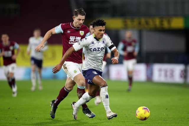 Ollie Watkins of Aston Villa is challenged by James Tarkowski of Burnley during the Premier League match between Burnley and Aston Villa at Turf Moor. (Photo by Clive Brunskill/Getty Images)