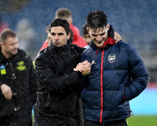 BURNLEY, ENGLAND - FEBRUARY 17:  Mikel Arteta, Manager of Arsenal, embraces his players Declan Rice following the Premier League match between Burnley FC and Arsenal FC at Turf Moor on February 17, 2024 in Burnley, England. (Photo by Stuart MacFarlane/Arsenal FC via Getty Images)