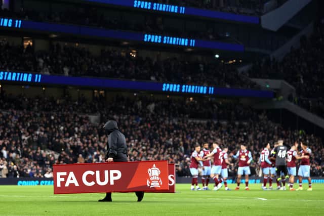 LONDON, ENGLAND - JANUARY 05: The Emirates FA Cup signs are carried off the pitch during the Emirates FA Cup Third Round match between Tottenham Hotspur and Burnley at Tottenham Hotspur Stadium on January 05, 2024 in London, England. (Photo by Alex Pantling/Getty Images)