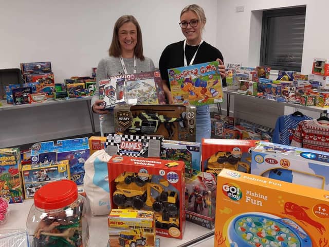 Burnley Together co-ordinator Nicola Larnach (left) with Ella Roberts, a customer service advisor for Calico, with some of the many toys and gifts donated by the public to the 2023 Christmas Present Appeal