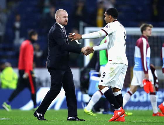Troy Deeney shakes hands with Sean Dyche during the Premier League match between Burnley and Watford at Turf Moor on September 26, 2016 in Burnley, England.