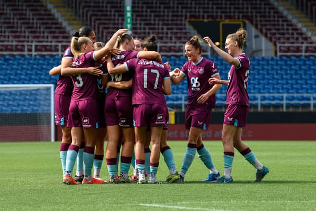 Burnley players celebrate with Millie Ravening after putting Burnley 3-0 up against Stoke City at Turf Moor. Photo: Kelvin Lister-Stuttard