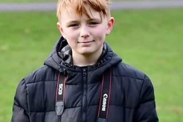 George Webster (12), volunteer photographer at Burnley parkrun in Towneley Park.