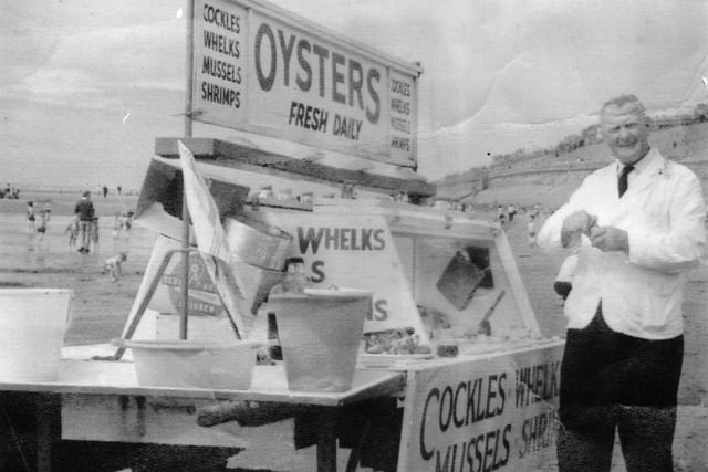 Lisa J Outerbridge: "Vinegar seafood slimey things! Can't remember their name winkles??? This is a photo from the 1963 which shows a seafood stall on the beach