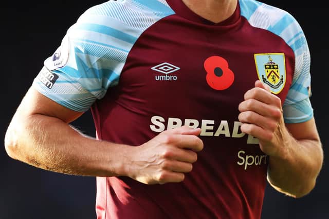 BURNLEY, ENGLAND - OCTOBER 30: A poppy is seen on a Burnley shirt as part of the Remembrance Day commemorations during the Premier League match between Burnley and Brentford at Turf Moor on October 30, 2021 in Burnley, England. (Photo by George Wood/Getty Images)