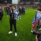 Burnley manager Vincent Kompany holds the Championship trophy
