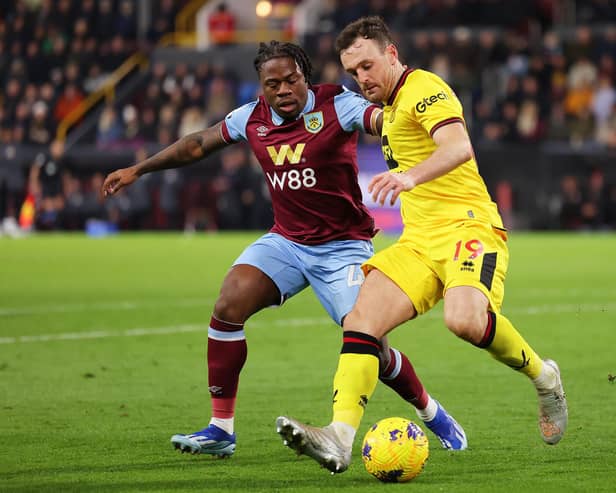 BURNLEY, ENGLAND - DECEMBER 02: Jack Robinson of Sheffield United battles for possession with Michael Obafemi of Burnley during the Premier League match between Burnley FC and Sheffield United at Turf Moor on December 02, 2023 in Burnley, England. (Photo by Matt McNulty/Getty Images)