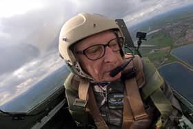 Alan Taylor (86) in the cockpit of a Spitfire flying over Lancashire