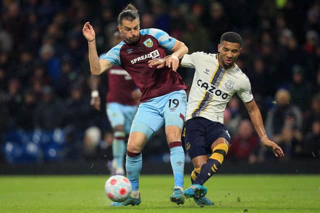 Burnley's English striker Jay Rodriguez (L) vies with Everton's English defender Mason Holgate (R) during the English Premier League football match between Burnley and Everton at Turf Moor in Burnley, north west England on April 6, 2022.