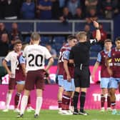 BURNLEY, ENGLAND - AUGUST 11: Referee Craig Pawson shows a red card to Anass Zaroury of Burnley during the Premier League match between Burnley FC and Manchester City at Turf Moor on August 11, 2023 in Burnley, England. (Photo by Nathan Stirk/Getty Images)