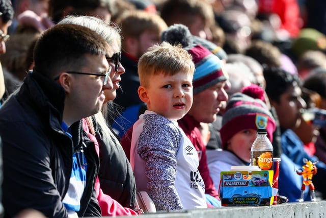 A young Burnley fan watches the game

Photographer Alex Dodd/CameraSport

The Premier League - Burnley v Manchester City - Saturday 2nd April 2022 - Turf Moor - Burnley
